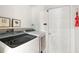 Laundry room with Samsung washer and dryer, and white cabinets at 14701 Timucua Pl, Clermont, FL 34711
