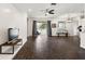 Spacious living room with dark hardwood floors and sliding glass doors leading to the patio at 14701 Timucua Pl, Clermont, FL 34711