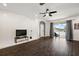 Living area with dark wood floors and access to the backyard at 14701 Timucua Pl, Clermont, FL 34711