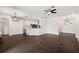 Open living room and kitchen area with dark wood flooring and updated kitchen at 14701 Timucua Pl, Clermont, FL 34711
