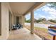 Covered patio with two blue chairs and a view of a fenced backyard at 14701 Timucua Pl, Clermont, FL 34711