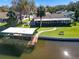 Waterfront home with private dock and lush landscaping at 1621 Texas Ct, Tavares, FL 32778