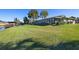 Large backyard with canal views and lush green grass at 1621 Texas Ct, Tavares, FL 32778