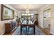 Elegant dining room featuring a large table, chandelier, and hardwood floors at 1621 Texas Ct, Tavares, FL 32778