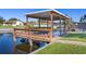 Wooden dock and covered seating area over the water at 1621 Texas Ct, Tavares, FL 32778