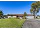 Single-story brick home with a landscaped yard and driveway at 1621 Texas Ct, Tavares, FL 32778