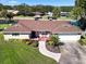 One-story home with brown roof, landscaping, and a water view at 1621 Texas Ct, Tavares, FL 32778