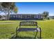 Inviting front yard with a welcoming bench and landscaping at 1621 Texas Ct, Tavares, FL 32778
