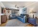 Cozy living room with blue leather couches and wood floors at 1621 Texas Ct, Tavares, FL 32778