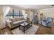 Living room with hardwood floors, large windows, and comfortable seating at 1621 Texas Ct, Tavares, FL 32778