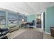 Bright sunroom featuring a workspace and access to other areas at 1621 Texas Ct, Tavares, FL 32778