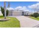 Single-Gathering home with a two-car garage and palm trees at 2249 Quincy Ct, The Villages, FL 32162