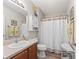 Clean bathroom with shower/tub combo, vanity, and linen storage at 2404 Travis Pl, The Villages, FL 32162