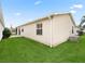 House exterior showcasing vinyl siding and a well-maintained lawn at 2404 Travis Pl, The Villages, FL 32162