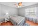 Serene bedroom with wood floors, ceiling fan and window coverings at 25004 Cranes Roost Cir, Leesburg, FL 34748