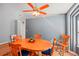 Inviting dining area featuring a round wooden table and blue chairs at 25004 Cranes Roost Cir, Leesburg, FL 34748