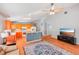 Kitchen with orange cabinets, an island, and hardwood floors at 25004 Cranes Roost Cir, Leesburg, FL 34748