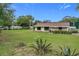 Single story home with a large lawn and mature landscaping at 25544 Creston Ave, Sorrento, FL 32776