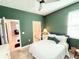 Bedroom with green walls and view into adjacent bathroom at 34004 Sky Blossom Cir, Leesburg, FL 34788