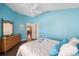 Guest bedroom with a comfy bed and wicker dresser, light blue walls at 3507 Vail Ct, The Villages, FL 32163