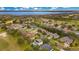 Aerial view of a lakefront community with lush landscaping and golf course at 4236 Fawn Meadows Cir, Clermont, FL 34711