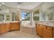 Large bathroom with double vanity, corner tub, and lots of natural light at 4236 Fawn Meadows Cir, Clermont, FL 34711