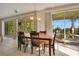 Casual dining area with a wooden table and chairs, and pool views at 4236 Fawn Meadows Cir, Clermont, FL 34711