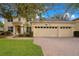 Two-story house with a three-car garage and a landscaped lawn at 4236 Fawn Meadows Cir, Clermont, FL 34711