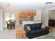Open floor plan kitchen with island, granite countertops, and adjacent Gathering room at 4236 Fawn Meadows Cir, Clermont, FL 34711