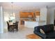 Open floor plan kitchen with island, granite countertops, and adjacent Gathering room at 4236 Fawn Meadows Cir, Clermont, FL 34711