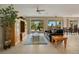 Spacious living room with tiled floors, a leather couch, and access to the pool area at 4236 Fawn Meadows Cir, Clermont, FL 34711