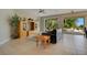 Living room with tiled floors, a leather couch, and views of the pool at 4236 Fawn Meadows Cir, Clermont, FL 34711