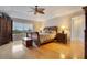 Main bedroom with hardwood floors, large window, and ceiling fan at 4236 Fawn Meadows Cir, Clermont, FL 34711