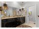 Elegant bathroom with double sinks, granite countertops, and modern fixtures at 426 Ellenton Run, The Villages, FL 32162