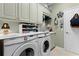 Laundry room with Samsung washer and dryer and ample cabinet space at 426 Ellenton Run, The Villages, FL 32162