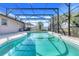 Refreshing kidney-shaped pool with screened enclosure at 8021 Cardinal Winds Ln, Mascotte, FL 34753