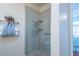 Walk-in shower with glass enclosure and built-in shelves at 872 Oviedo Rd, The Villages, FL 32159