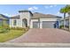 Two-story home with a two-car garage and landscaped yard at 955 Ladera Ranch Rd, Kissimmee, FL 34759