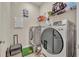 Laundry room with washer, dryer, and shelving at 955 Ladera Ranch Rd, Kissimmee, FL 34759