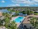 Aerial view of community pool and clubhouse near a lake at 955 Ladera Ranch Rd, Kissimmee, FL 34759