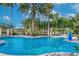 Relaxing resort-style pool with palm trees and lounge chairs at 955 Ladera Ranch Rd, Kissimmee, FL 34759