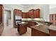 Large kitchen with dark wood cabinets, granite counters, and island at 9813 Santa Clara Ct, Howey In The Hills, FL 34737