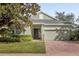 Single-story home with two-car garage and landscaping at 1063 Mesa Verde Ct, Clermont, FL 34711