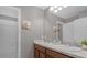 Bathroom with double vanity, granite countertop, and access to tub at 1150 Blarney St, Minneola, FL 34715
