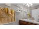 Small bathroom with a single sink, floating shelves, and gold accents at 1150 Blarney St, Minneola, FL 34715