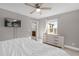 Spacious bedroom with a queen bed, dresser, and view of another room at 1150 Blarney St, Minneola, FL 34715