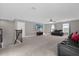 Spacious bonus room with two leather sofas and a large TV at 1150 Blarney St, Minneola, FL 34715