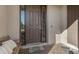 Front entry with brown door, brick walkway, and bench at 1150 Blarney St, Minneola, FL 34715