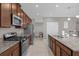 Modern kitchen with stainless steel appliances and granite countertops at 1150 Blarney St, Minneola, FL 34715