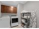 Laundry room with washer, dryer, shelving, and cabinets at 1150 Blarney St, Minneola, FL 34715
